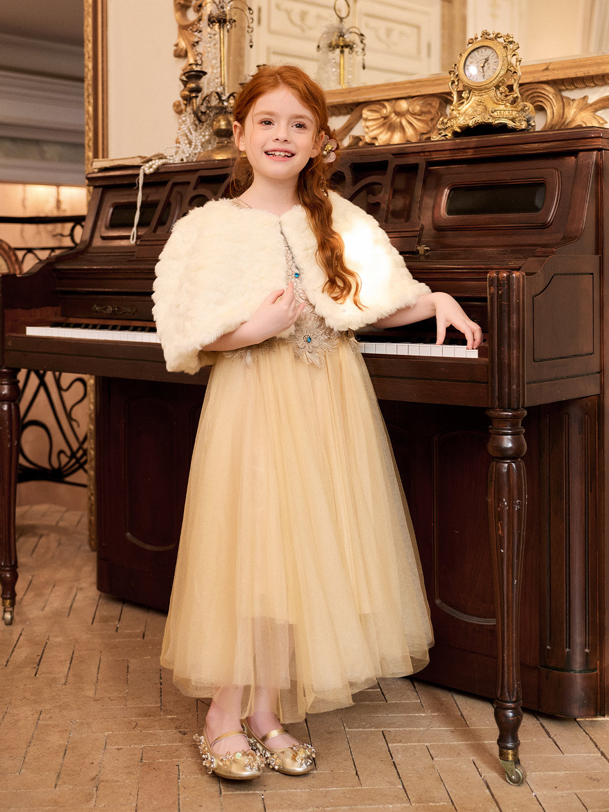 Model wearing the champagne embroidered dress with the included ivory cape