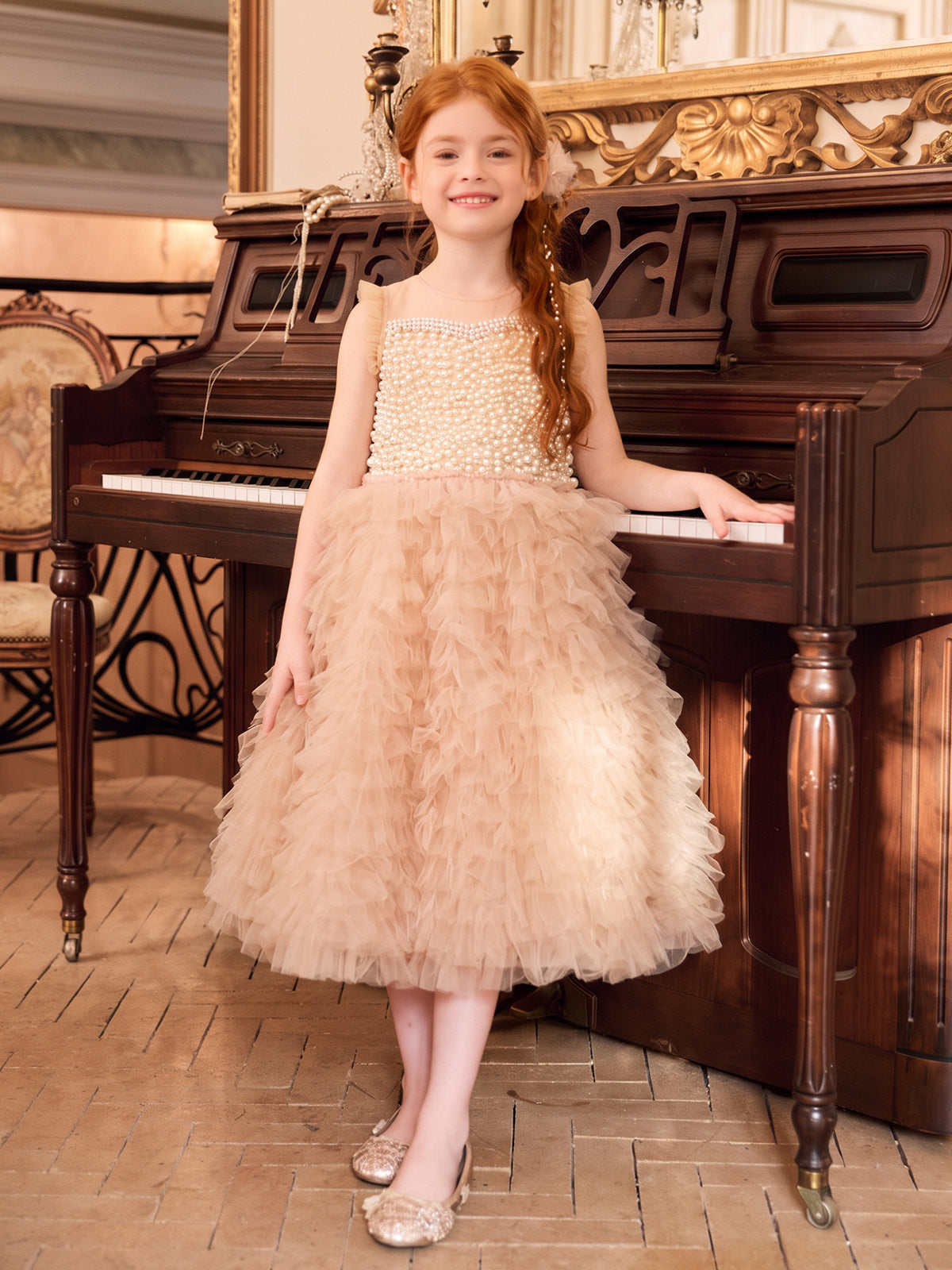 Apricot pearl-style bodice with shoulder frills and a densely ruffled tulle skirt