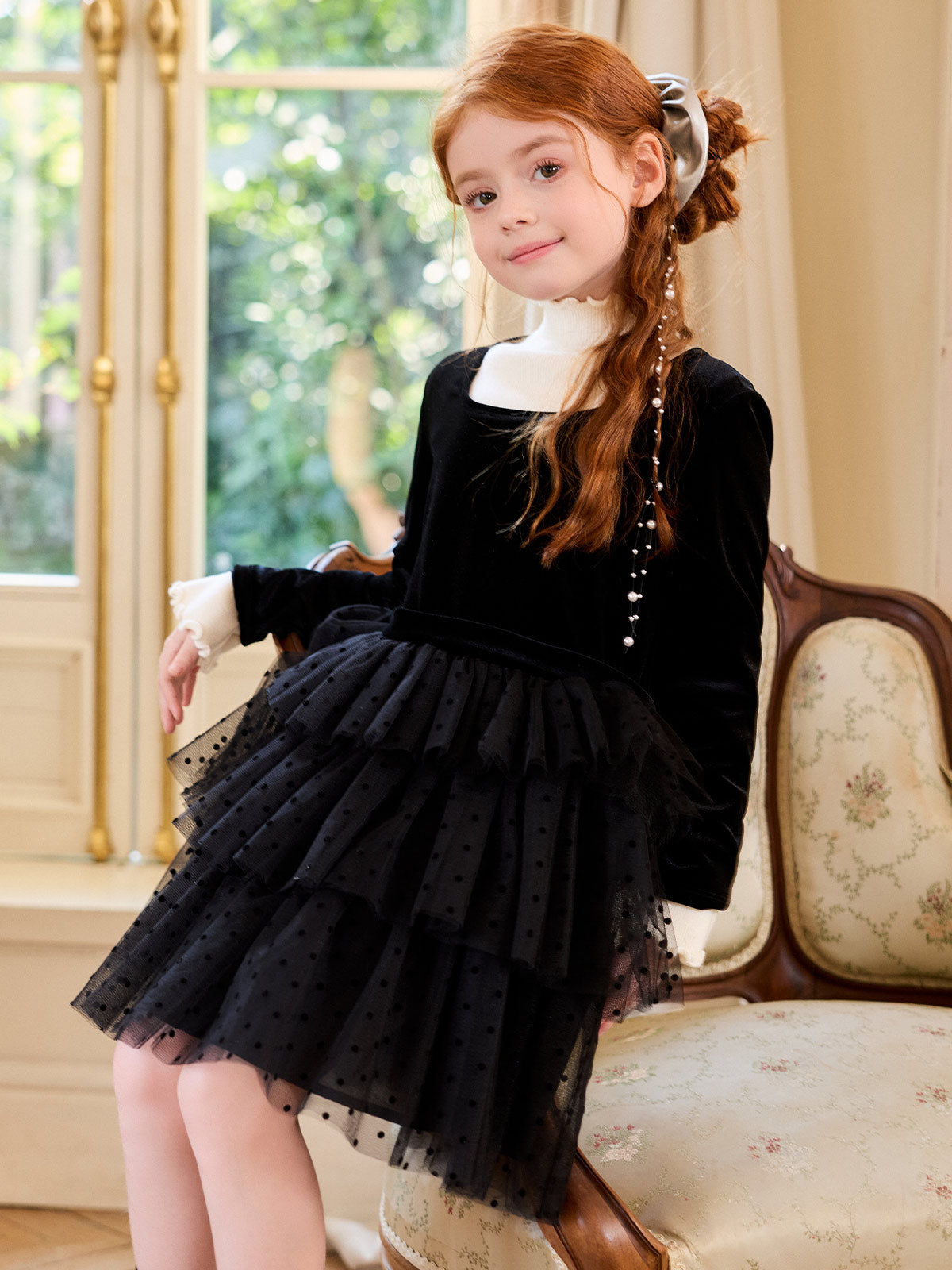 Seated side styling view of the Black Velvet Polka Dot Tier Dress