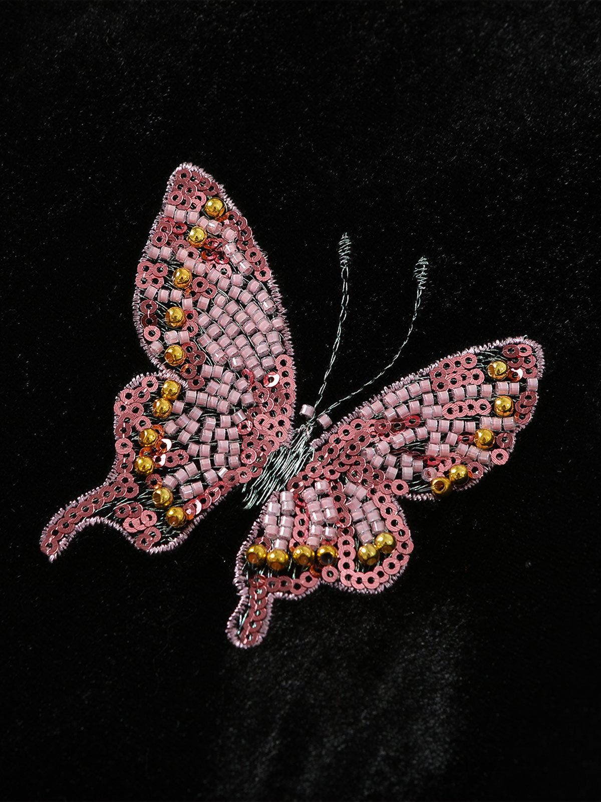 Hand-beaded pink butterfly applique on black velvet