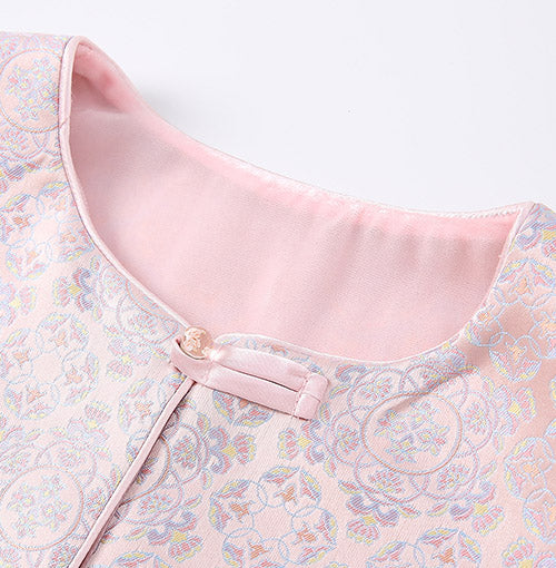 Soft curved neckline and polished button detail