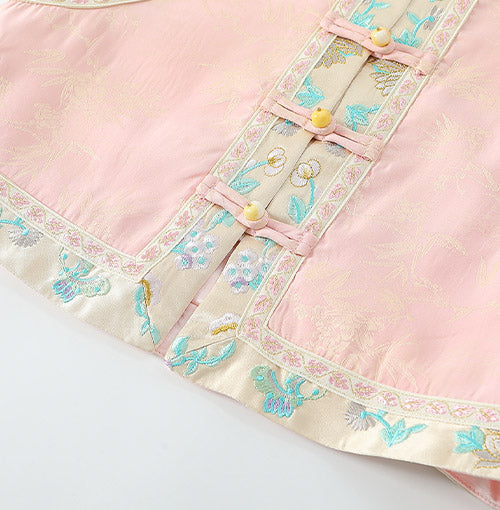 Pastel floral brocade border at the vest hem