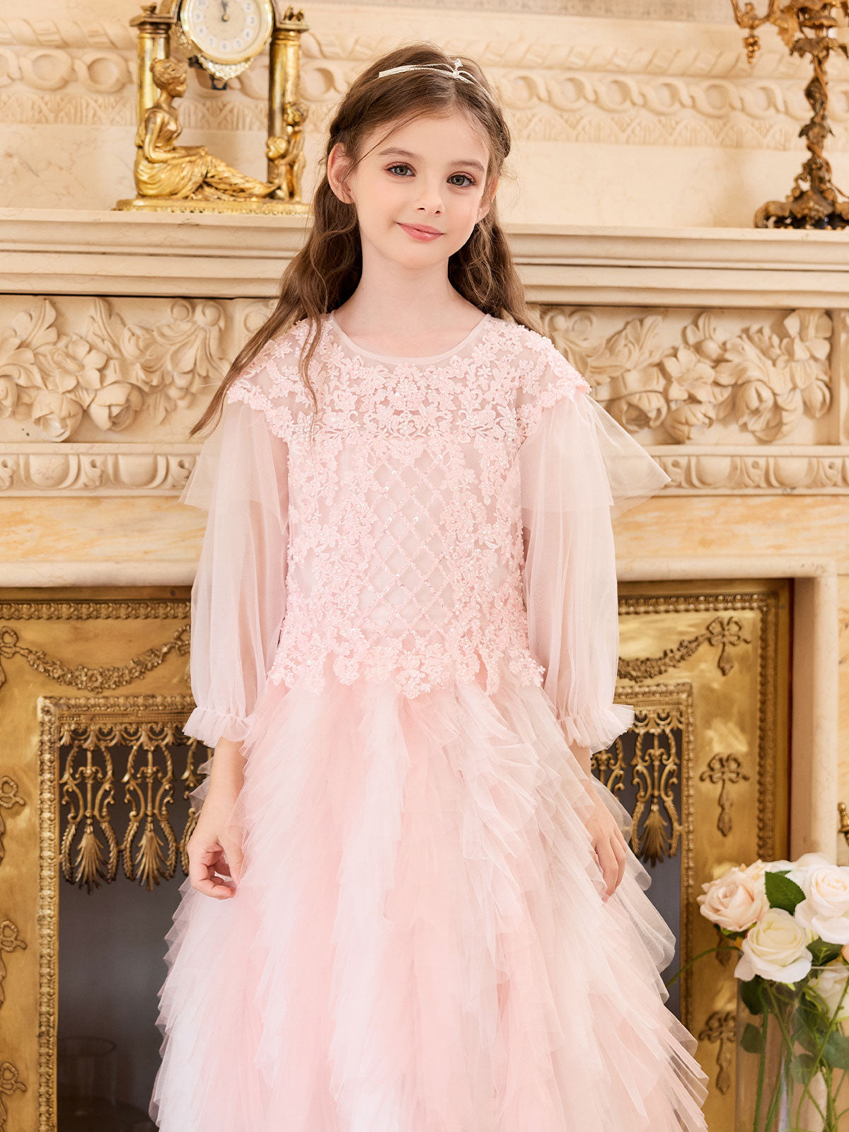 Girl wearing the Blush Beaded Cascade Tulle Gown with sheer sleeves