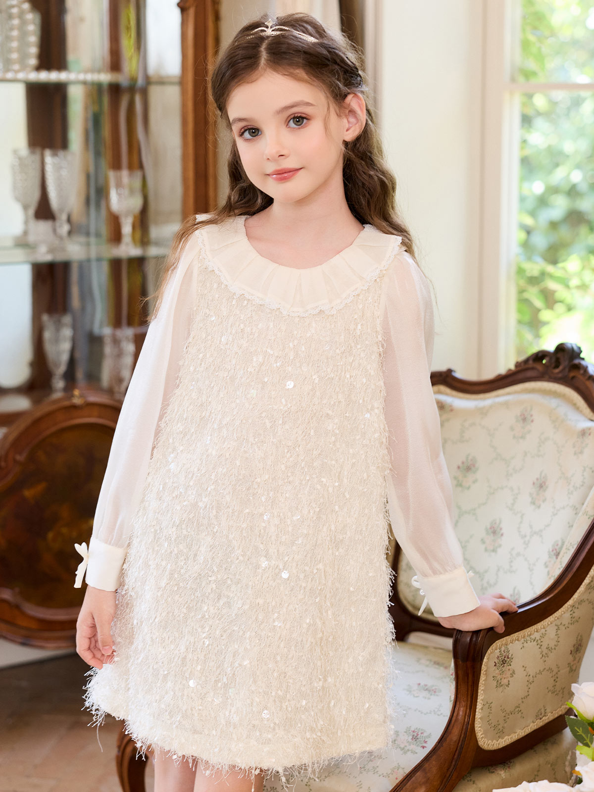 Girl wearing the Ivory Fringe Glow Dress