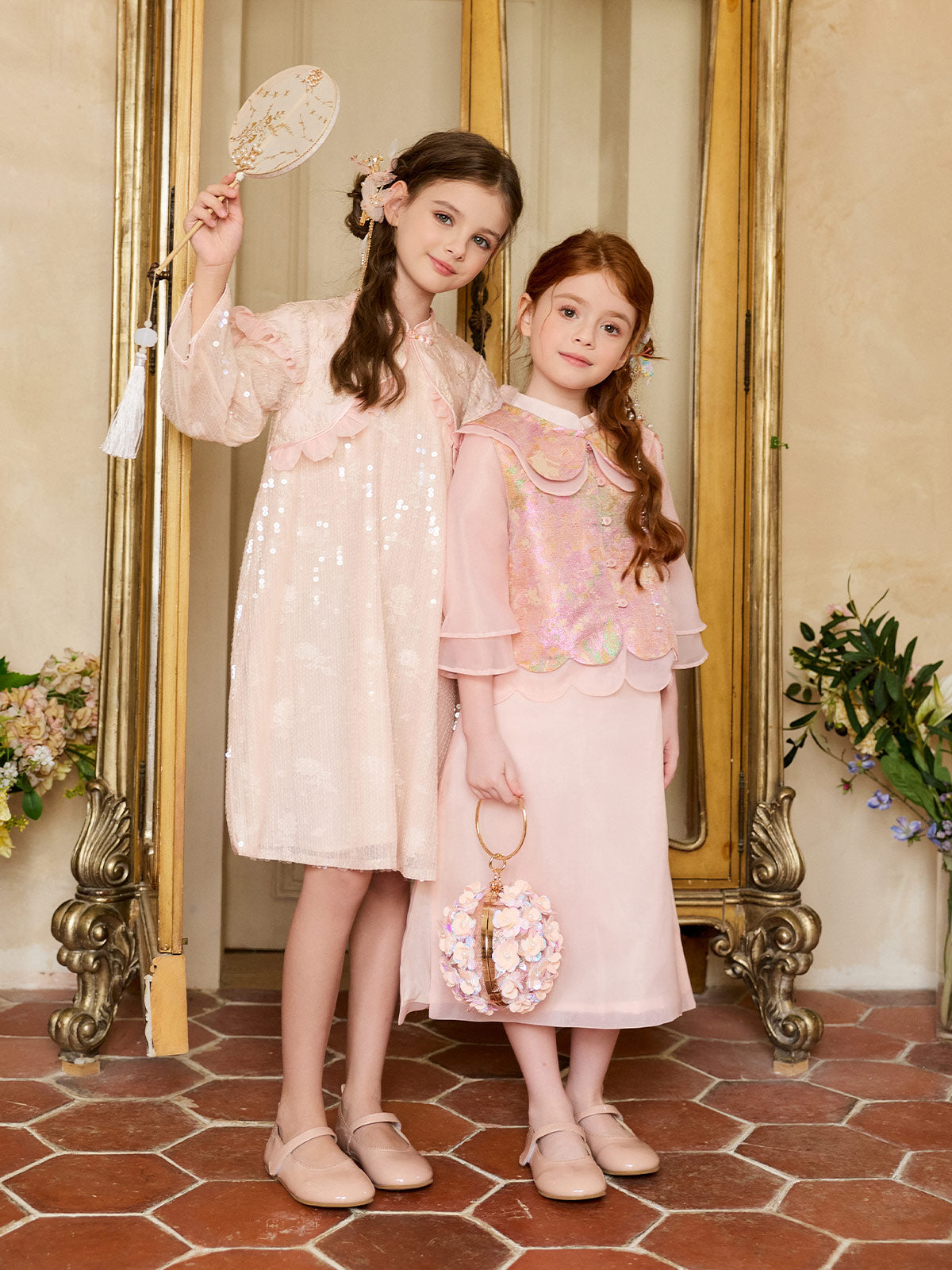 Full-length styling view of the Blush Sparkle Lotus Cape Dress
