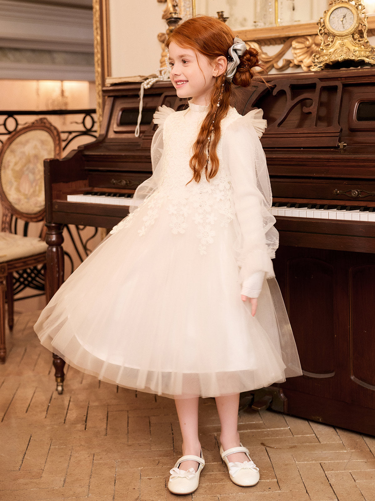 Full-length side model view of the ivory lace knit and tulle dress