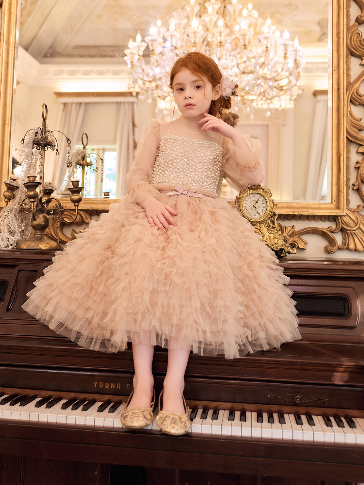 Apricot pearl-style bodice with sheer long sleeves and a densely ruffled tulle skirt