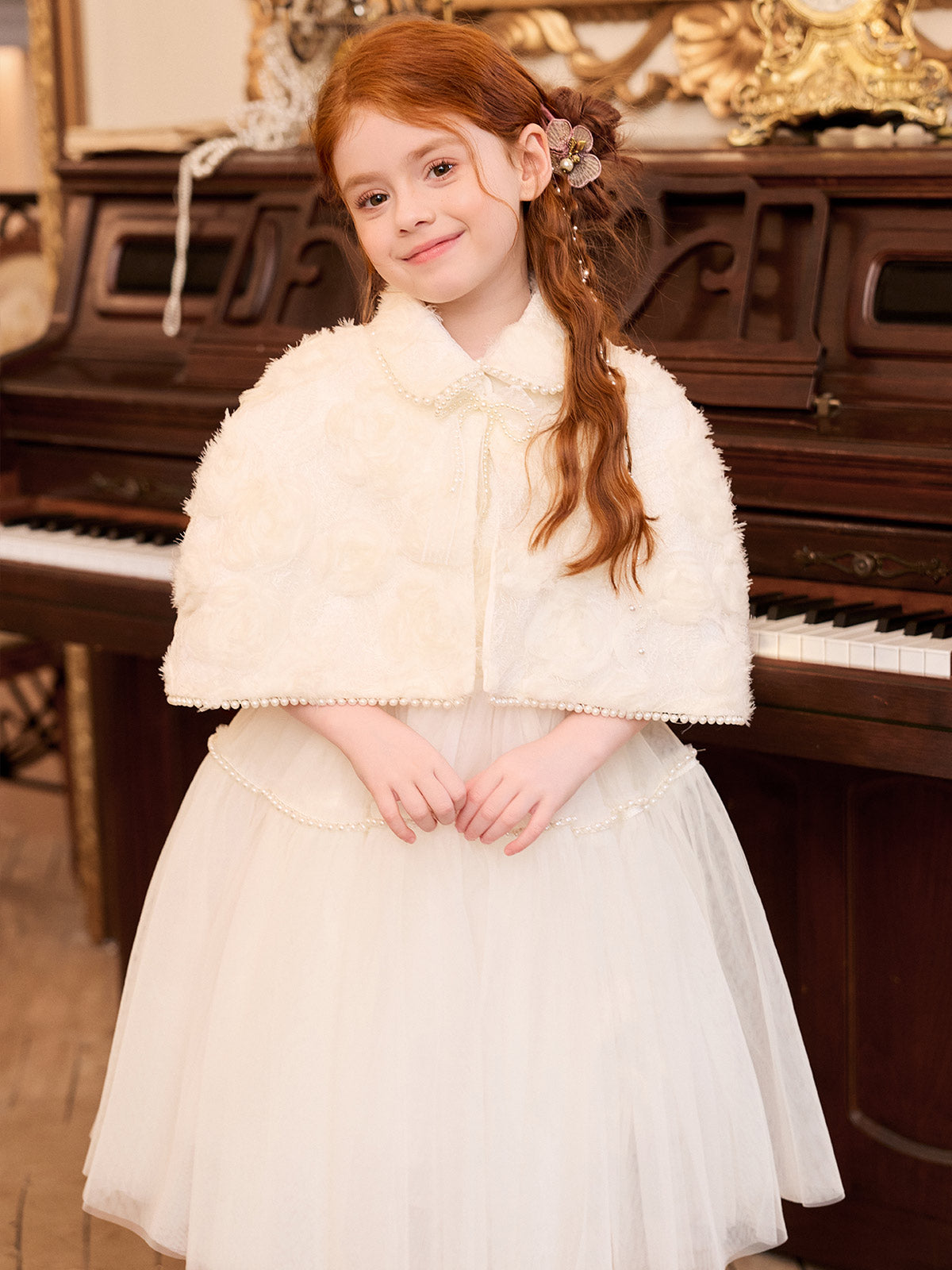 Front styling view of the matching pearl-trimmed cape and dress
