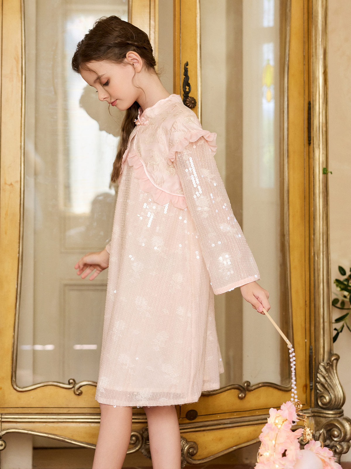 Side model view of the Blush Sparkle Lotus Cape Dress