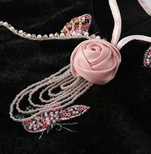 Blush rose neckline with pearl-style tassel detail