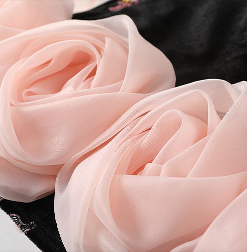 Sculptural blush organza roses around the hem